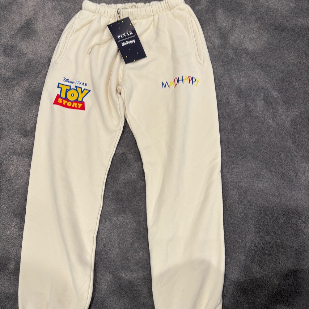 Madhappy Cream Sweatpants with Toy Story Embroidery